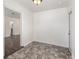 Cozy dining room features stylish gray tiled flooring, freshly painted white walls and an entry door to the backyard at 416 Davis Dr, Orlando, FL 32803