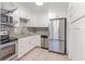 Well-equipped kitchen featuring stainless steel appliances, granite countertops, and crisp white cabinets at 416 Davis Dr, Orlando, FL 32803