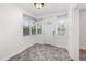 Enclosed front porch with multiple windows, tile floors, and a front door at 416 Davis Dr, Orlando, FL 32803