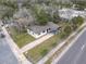 Aerial view of a single-story home with a driveway, surrounded by mature trees in a residential neighborhood at 425 Walnut St, Daytona Beach, FL 32114
