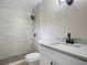Updated bathroom features a tiled shower with rainfall showerhead, a modern vanity, and stylish finishes at 425 Walnut St, Daytona Beach, FL 32114