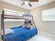 Cozy bedroom with tile flooring, a ceiling fan, a comfortable bed, and a window for natural lighting at 425 Walnut St, Daytona Beach, FL 32114