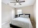 Cozy bedroom with tile flooring, a ceiling fan, a comfortable bed, and a window for natural lighting at 425 Walnut St, Daytona Beach, FL 32114