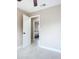 Empty bedroom with neutral walls, tile floors, and a view to an adjacent bedroom through an open door frame at 425 Walnut St, Daytona Beach, FL 32114