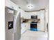 Modern kitchen with white cabinets, stainless steel appliances, and tiled flooring for a clean and bright space at 425 Walnut St, Daytona Beach, FL 32114