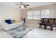 Inviting living room featuring tile floors, a ceiling fan, a comfortable sofa, and natural light from a large window at 425 Walnut St, Daytona Beach, FL 32114