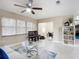 Comfortable living room with ceiling fan, open to the dining area, and featuring neutral paint and tile flooring at 425 Walnut St, Daytona Beach, FL 32114
