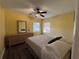 Sunny bedroom with wood-look floors, dresser, and a ceiling fan at 433 S Lee Ave, Orlando, FL 32805