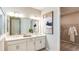 Bathroom featuring double sinks, a large mirror, and a walk-in closet at 4698 Coral Harbour Rd, Kissimmee, FL 34758