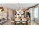 Cozy dining area featuring a decorative light fixture and views into the adjacent kitchen area with white cabinets at 4698 Coral Harbour Rd, Kissimmee, FL 34758