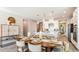 Cozy dining area with an oval table, pendant lighting, and views into the kitchen with white countertops at 4698 Coral Harbour Rd, Kissimmee, FL 34758