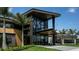 Modern building featuring expansive glass windows, palm trees, and meticulously maintained landscaping at 4698 Coral Harbour Rd, Kissimmee, FL 34758