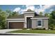 Charming single-story home showcasing a neutral color scheme, well-maintained lawn, and attached two car garage at 4698 Coral Harbour Rd, Kissimmee, FL 34758
