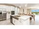 Modern kitchen with stainless steel appliances, white cabinets, and a center island with a sink at 4698 Coral Harbour Rd, Kissimmee, FL 34758