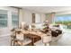 Open-concept living room with dining area, modern decor, and sliding glass doors to the lanai at 4698 Coral Harbour Rd, Kissimmee, FL 34758