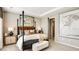 Comfortable main bedroom with a four-poster bed, neutral colors, and stylish decorations at 4698 Coral Harbour Rd, Kissimmee, FL 34758