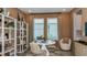 Bright home office with stylish decor, a white desk, and a comfortable seating area at 4698 Coral Harbour Rd, Kissimmee, FL 34758