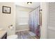 Bathroom featuring wood-look floors, geometric shower curtain, and a single sink vanity at 5019 Log Wagon Rd, Ocoee, FL 34761