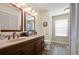 Bathroom with double sinks, wooden floors, and plenty of storage space at 5019 Log Wagon Rd, Ocoee, FL 34761