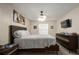 Bright bedroom featuring a ceiling fan, television, and neutral walls at 5019 Log Wagon Rd, Ocoee, FL 34761