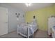 Bright bedroom with yellow and blue walls, carpet floors, and a ceiling fan at 5019 Log Wagon Rd, Ocoee, FL 34761