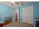 Unfurnished bedroom featuring blue walls, carpet floors, white closet doors and a ceiling fan at 5019 Log Wagon Rd, Ocoee, FL 34761