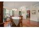 Cozy dining room with hardwood floors, classic furniture, and view of front door at 5019 Log Wagon Rd, Ocoee, FL 34761