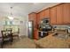 Cozy kitchen features stainless steel appliances, a breakfast table and granite countertops at 5019 Log Wagon Rd, Ocoee, FL 34761