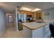 Well-equipped kitchen with stainless steel appliances, light wood cabinetry, and breakfast bar overlooking the dining area at 5201 S Atlantic Ave # 301A, New Smyrna Beach, FL 32169