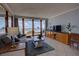Living room with comfortable seating, TV, and sliding glass doors leading to ocean view balcony at 5201 S Atlantic Ave # 301A, New Smyrna Beach, FL 32169