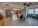 Open-concept living and dining area featuring tile floors, ceiling fan, and adjacent kitchen for seamless entertaining at 5201 S Atlantic Ave # 301A, New Smyrna Beach, FL 32169