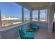 Bright sitting room featuring comfortable teal chairs and expansive ocean views through large windows at 5201 S Atlantic Ave # 301A, New Smyrna Beach, FL 32169