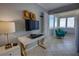 Relaxing sun room features comfortable seating, tile floors, and panoramic views of the surrounding landscape at 5201 S Atlantic Ave # 301A, New Smyrna Beach, FL 32169
