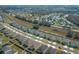 A new residential area with similar homes, neat lawns, and a railway line running nearby are captured in an aerial shot at 5342 Maddie Dr, Haines City, FL 33844