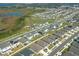 Modern homes in a planned community feature neat landscaping near a wetland area and winding roads, aerial view at 5342 Maddie Dr, Haines City, FL 33844