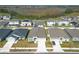 Aerial view of a residential neighborhood showcases well-maintained homes and proximity to a wetland area at 5342 Maddie Dr, Haines City, FL 33844