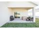 Covered patio with outdoor seating and a grill, perfect for enjoying backyard cookouts and relaxation at 5342 Maddie Dr, Haines City, FL 33844