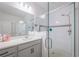 Bathroom with double vanity and a glass enclosed shower with gray tiling and hardware at 5342 Maddie Dr, Haines City, FL 33844