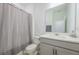 Modern bathroom featuring a white vanity, shower with geometric patterned curtain, and a commode at 5342 Maddie Dr, Haines City, FL 33844