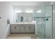 Bathroom with double vanity and a glass enclosed shower with gray tiling and hardware at 5342 Maddie Dr, Haines City, FL 33844
