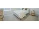 Cozy bedroom with carpet, neutral walls, and gold bed frame, plus natural light from the window at 5342 Maddie Dr, Haines City, FL 33844