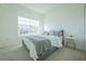 Bright bedroom with a large window, carpet, and a bed with gray and white bedding at 5342 Maddie Dr, Haines City, FL 33844