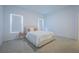 Minimalist bedroom with neutral tones, including two windows with privacy screens and an upholstered bed at 5342 Maddie Dr, Haines City, FL 33844
