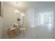 Dining room with a modern table, four chairs, and a decorative light fixture at 5342 Maddie Dr, Haines City, FL 33844