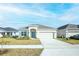Charming single-story home with well manicured lawn, 2 car garage, and inviting curb appeal at 5342 Maddie Dr, Haines City, FL 33844