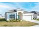 Inviting single-story home showcasing a well-kept lawn, neutral paint, and a two-car garage at 5342 Maddie Dr, Haines City, FL 33844