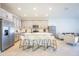 Modern eat-in kitchen featuring an island, sleek appliances, light grey cabinets, and stylish bar stools at 5342 Maddie Dr, Haines City, FL 33844