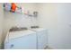 Functional laundry room with a washer, dryer, and shelving for storage, ensuring convenience and organization at 5342 Maddie Dr, Haines City, FL 33844