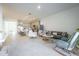 Spacious living area featuring tile flooring, modern furniture, and an open layout that connects to the kitchen at 5342 Maddie Dr, Haines City, FL 33844