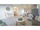 Bright, open-concept living room with modern decor, including white furniture and a stylish marble-topped coffee table at 5342 Maddie Dr, Haines City, FL 33844